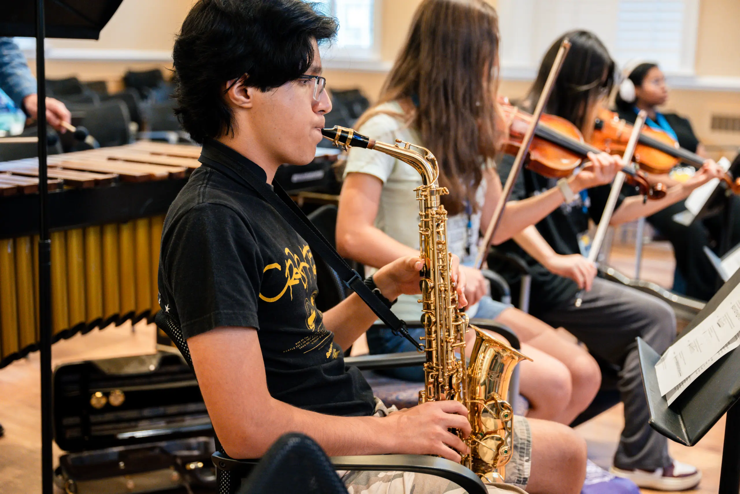 Student playing saxophone during music class